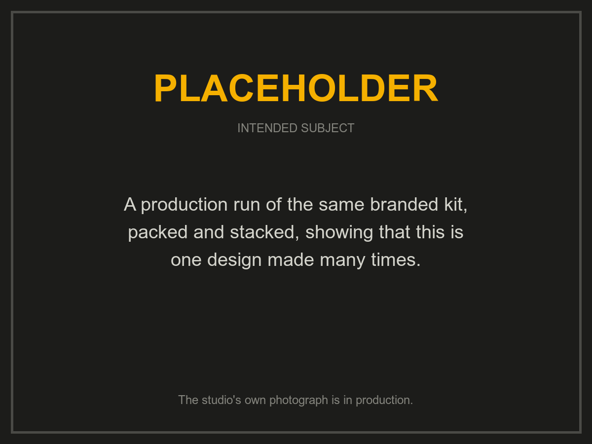 Placeholder: a production run of one branded kit, packed and stacked. The studio's own photograph is in production.