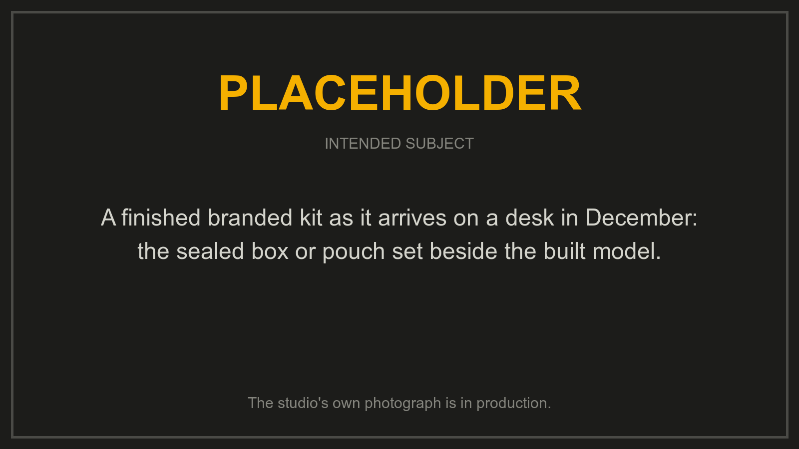 Placeholder: a branded building kit and the model built from it, on a desk. The studio's own photograph is in production.