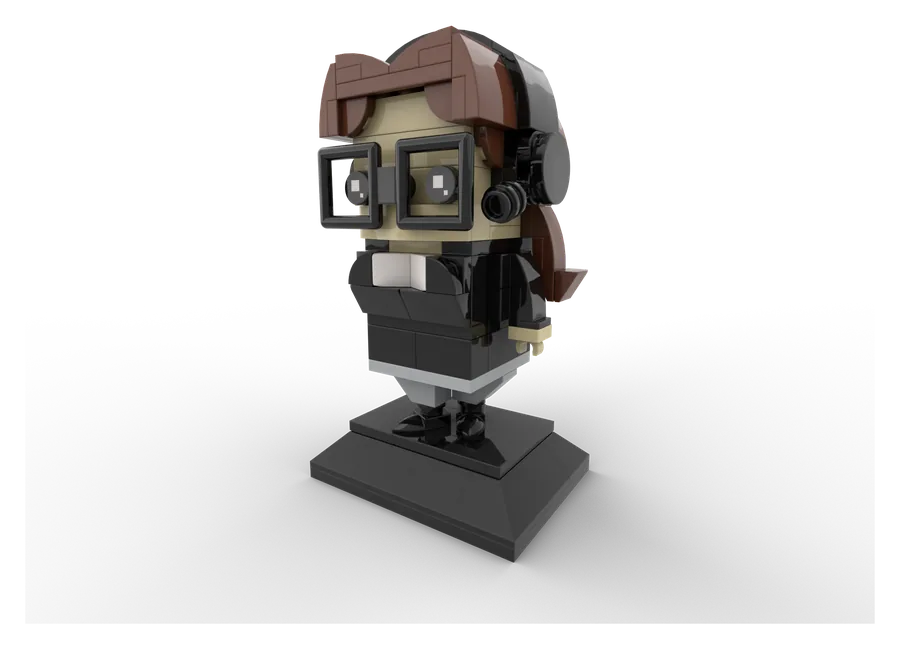 A creator rendered as a brick-built character figure on a display stand, with headphones, glasses and a camera.