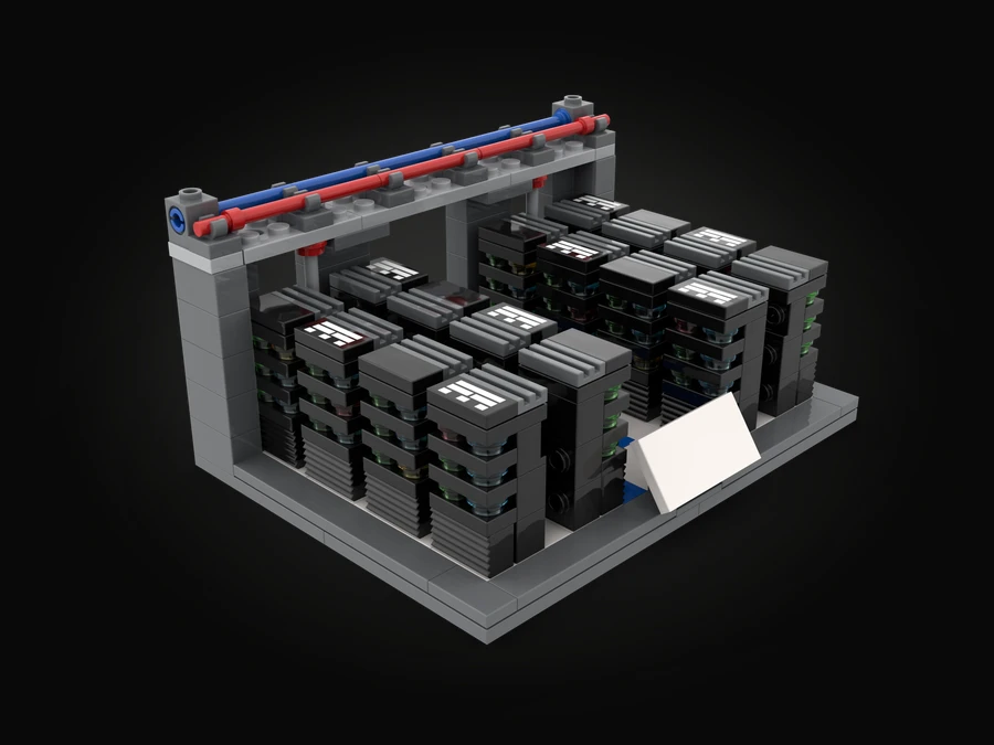A data center built from LEGO® bricks: rows of black server racks with printed tiles on top, under an overhead frame carrying a red and a blue pipe, on a grey floor.